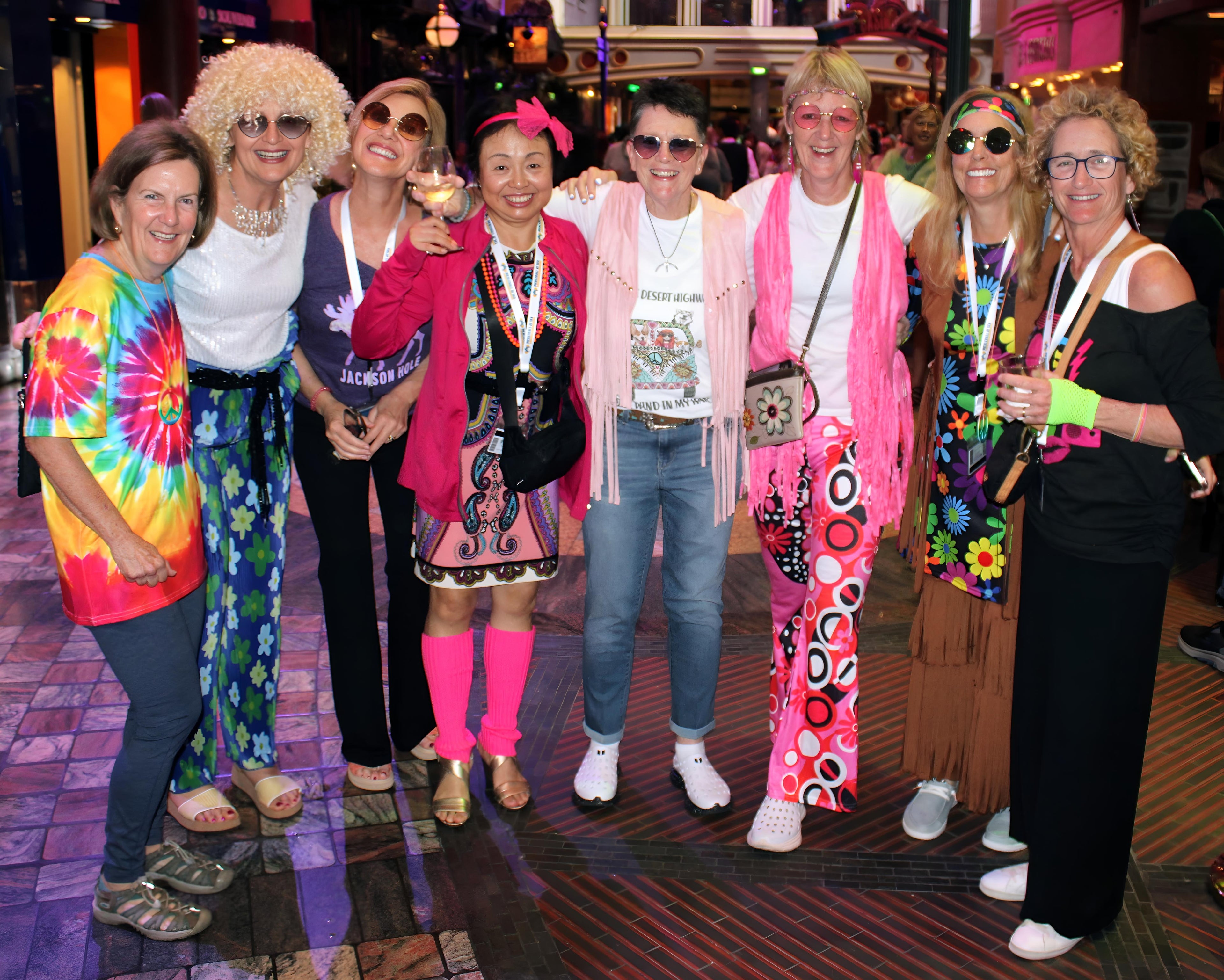 Pickleball At Sea Group Cruise Guests dressed in fun 70s and 80s costumes enjoying a themed dance party onboard during their Pickleball vacation.